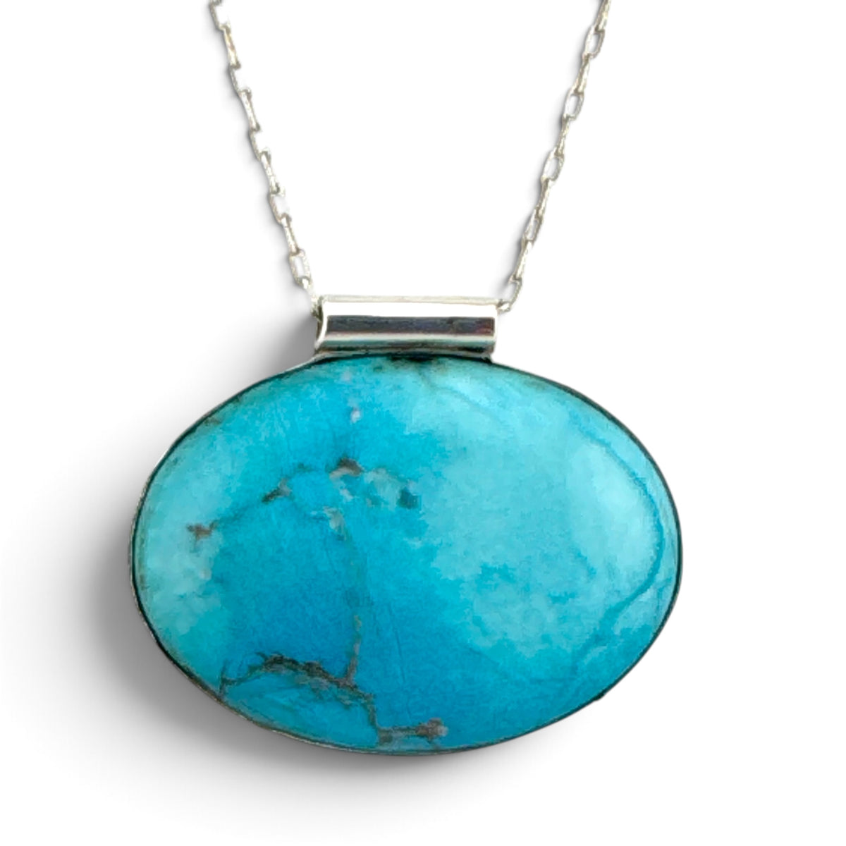 Close front view of reclaimed turquoise-blue stone in handmade recycled sterling silver bezel